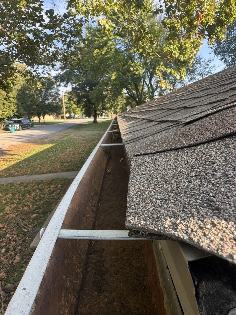 Gutter after debris removal, with existing staining still visible