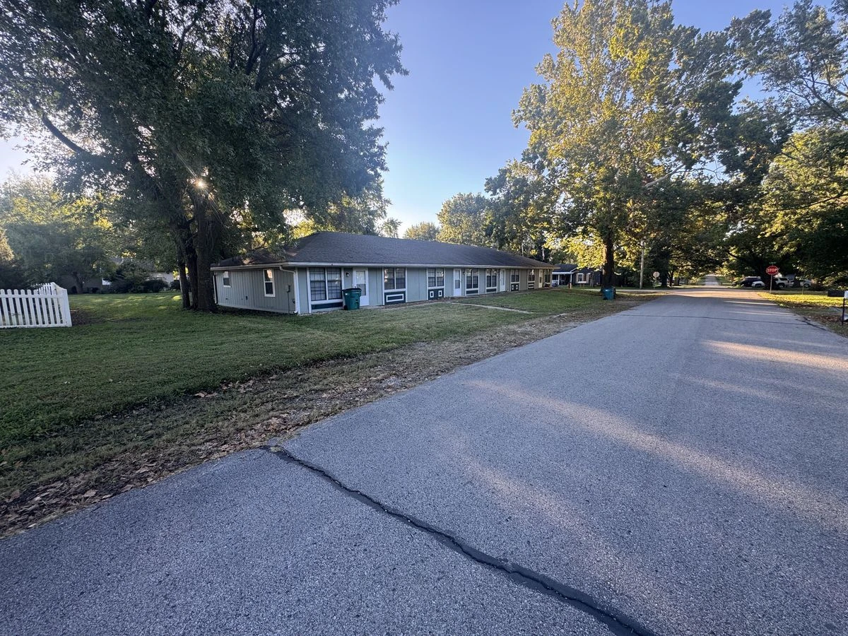 The same property with lawn mowing and cleanup completed, from a different viewpoint